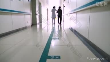 4K医疗_ 一名护士搀扶老人走健康步道